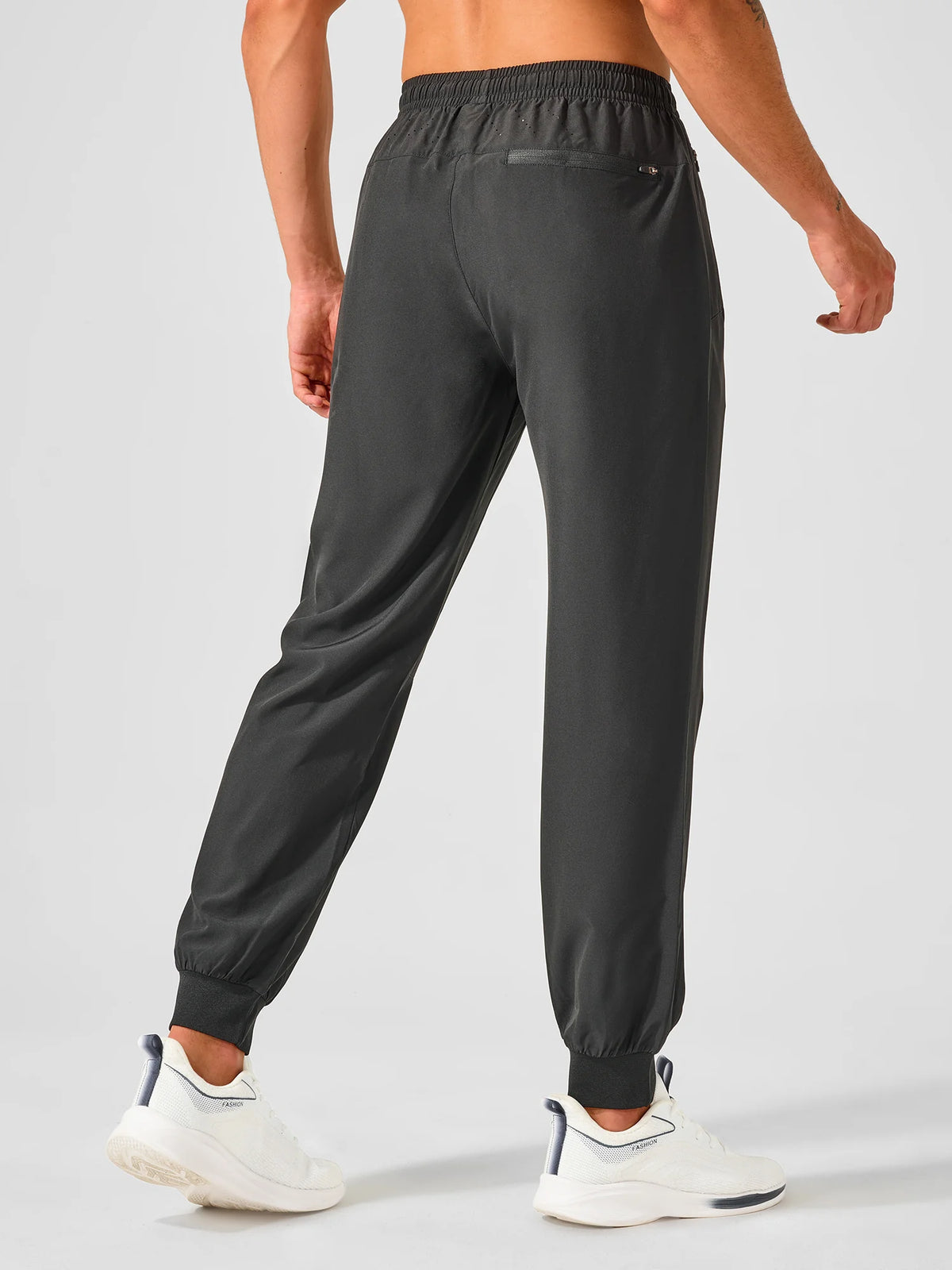 
Men's Tapered Running Workout Joggers with 3 Zipper Pockets — NORTHYARD men's black tapered workout joggers, back view on model — black