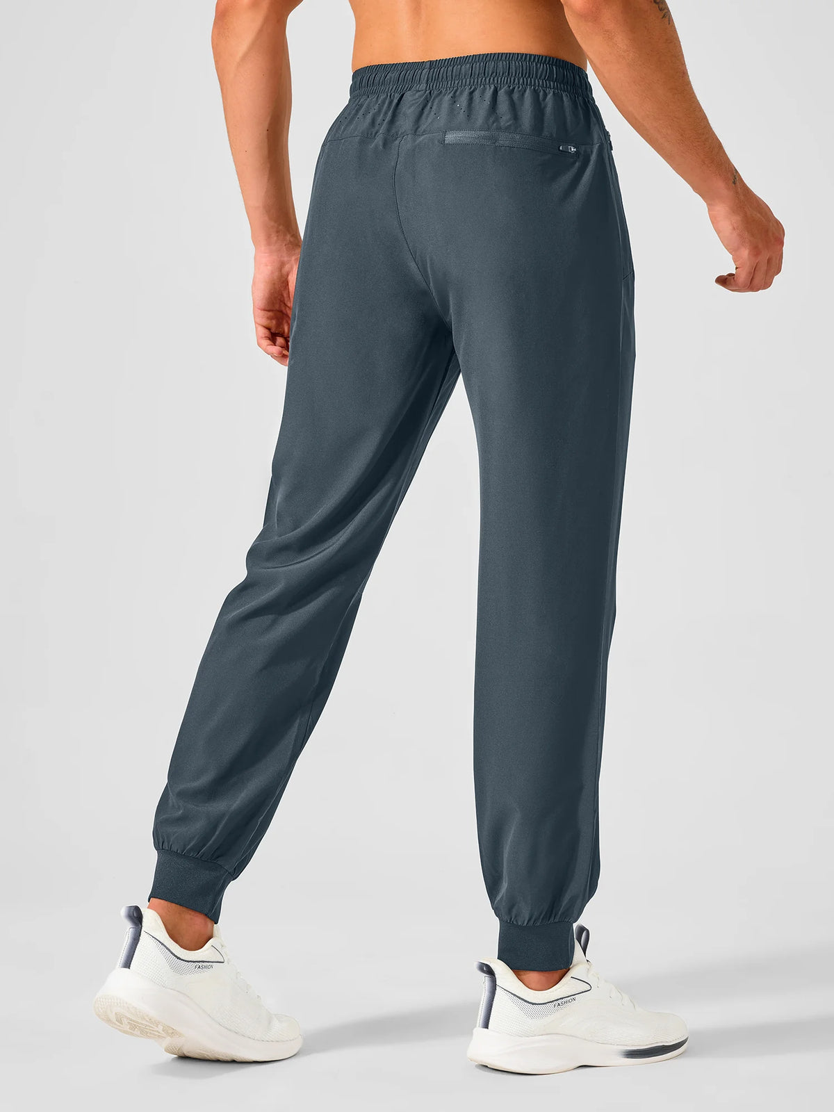 
Men's Tapered Running Workout Joggers with 3 Zipper Pockets — NORTHYARD men's cool grey tapered workout joggers, back view on model — cool grey