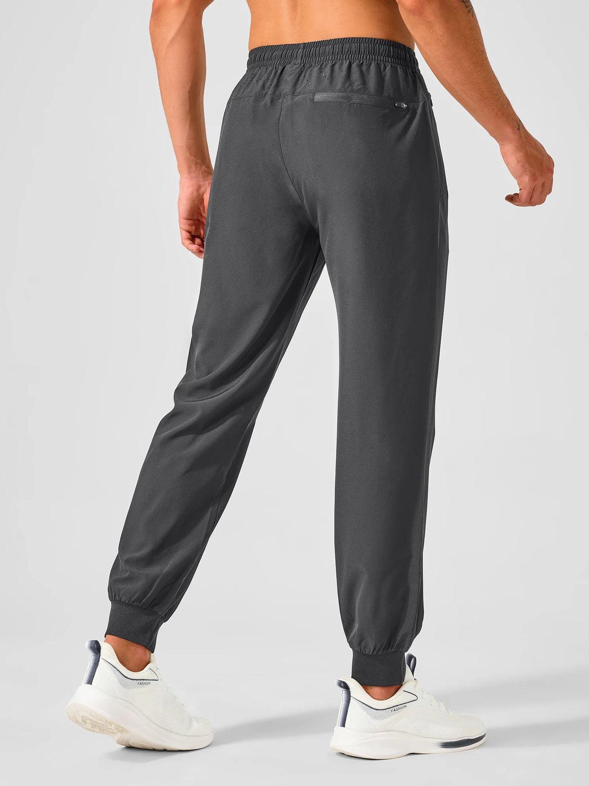 
Men's Tapered Running Workout Joggers with 3 Zipper Pockets — NORTHYARD men's dark grey tapered workout joggers, back view on model — dark grey