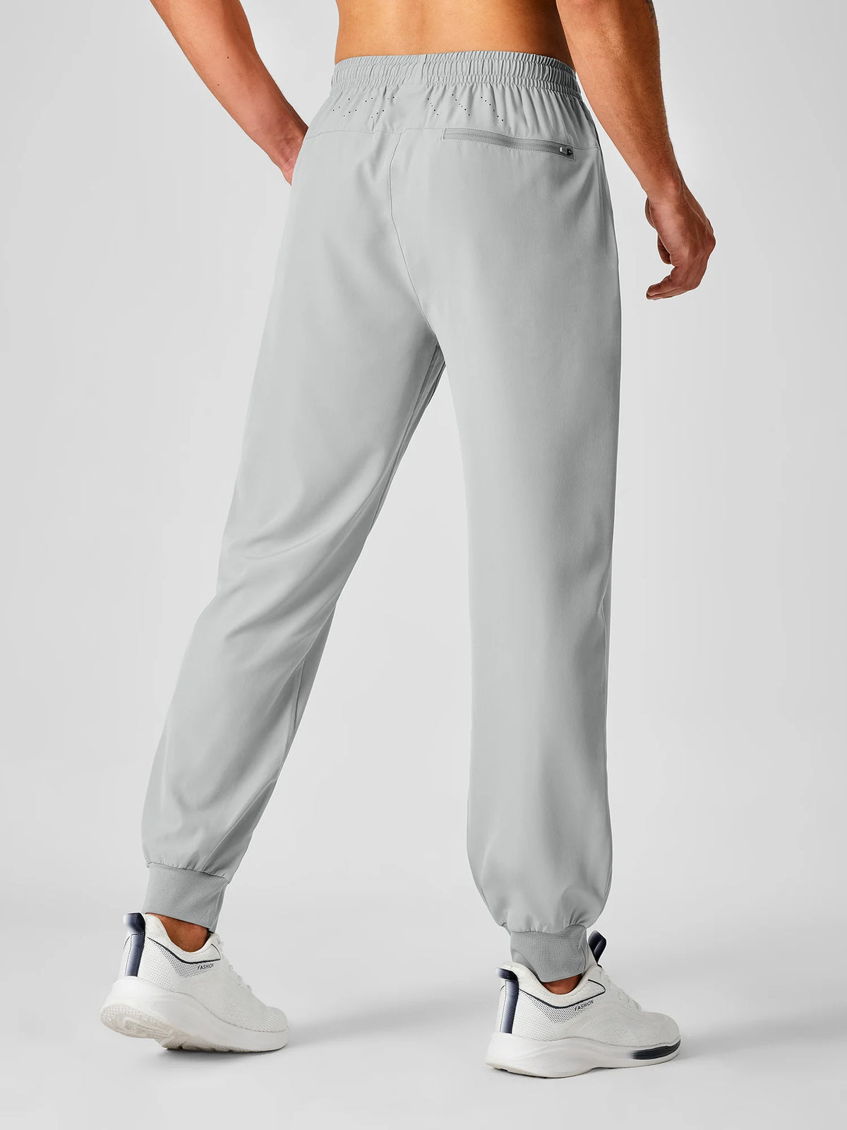 
Men's Tapered Running Workout Joggers with 3 Zipper Pockets — NORTHYARD men's light grey tapered workout joggers, back view on model — light grey