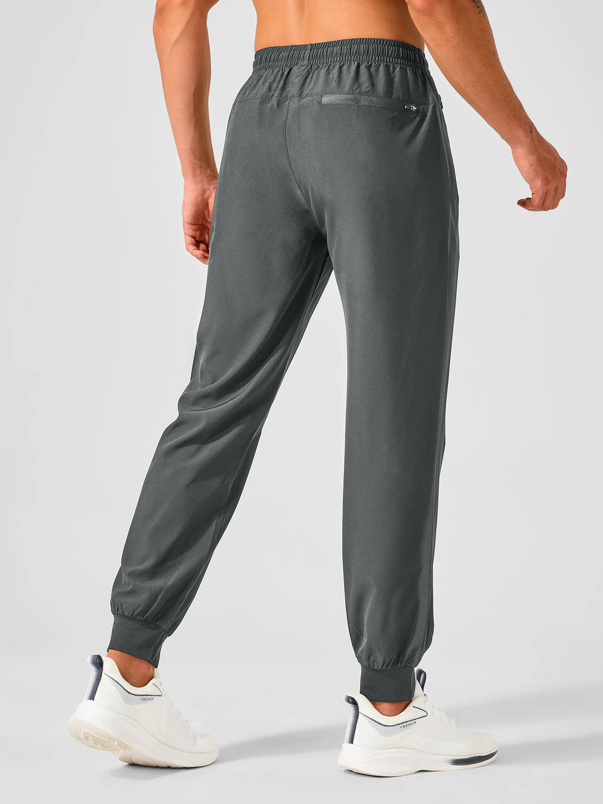 
Men's Tapered Running Workout Joggers with 3 Zipper Pockets — NORTHYARD men's smoke grey tapered workout joggers, back view on model — smoke grey